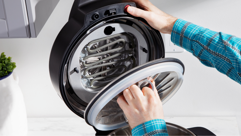 A person replacing the pressure cooker for the Instant Pot.