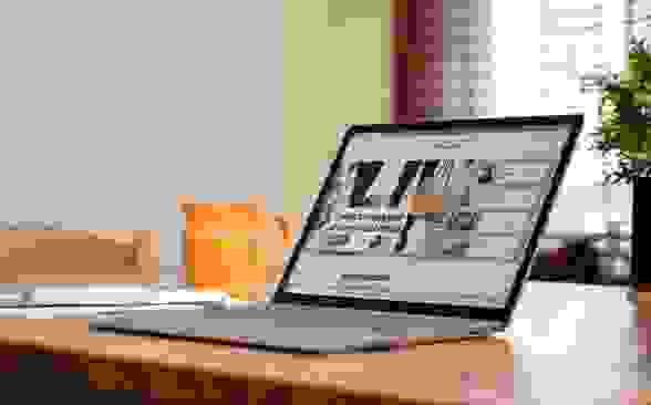 An open and powered on laptop displaying a website on its screen