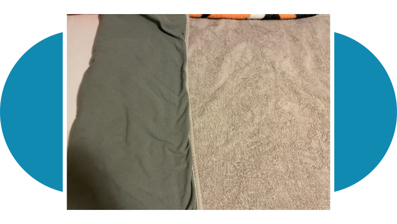Gray Peapod bedwetting mat on top of mattress with covers.