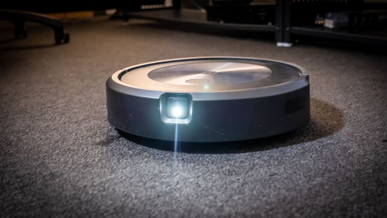 The forward-facing camera of the iRobot Roomba j7+ with its light on