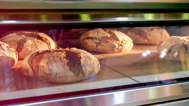 Loaves of bread baking in an oven.