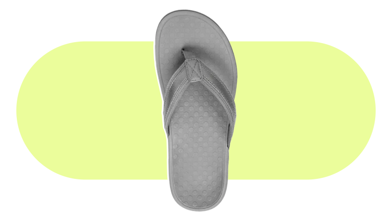 The Vionic sandal on a yellow background.