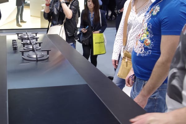 Crowd at Design Week Looks at Stainless Cooktop