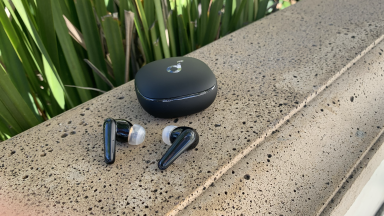 The Anker Soundcore Liberty 4 earbuds next to their case.