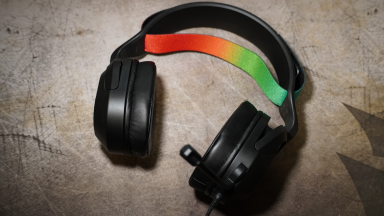 The JLab Nightfall gaming headset with a rainbow-colored ban on the top of the headphones.