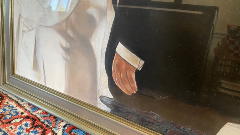 A close up look at an oil painting focuses on a man's hand, which looks not really natural.