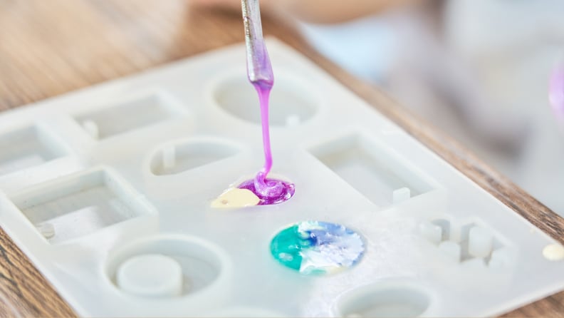 a pipette pouring resin into a silicone mold