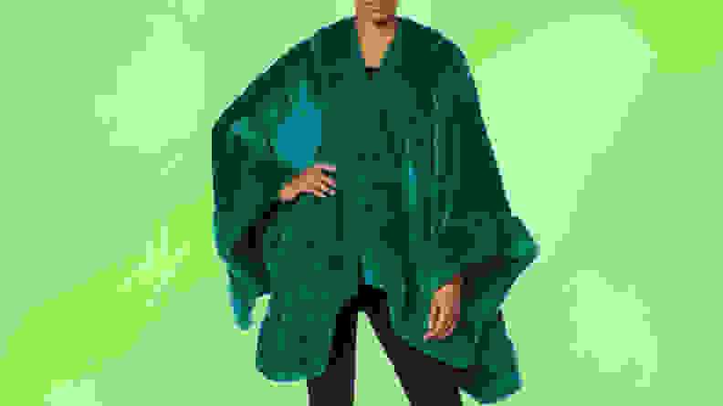 A person wearing a dark green background in front of a green background.