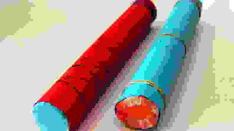 Two rain sticks made from construction paper and paper towel rolls