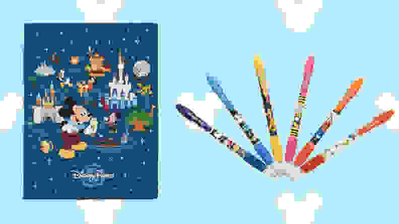 mickey notebook and rainbow pens on light blue disney background