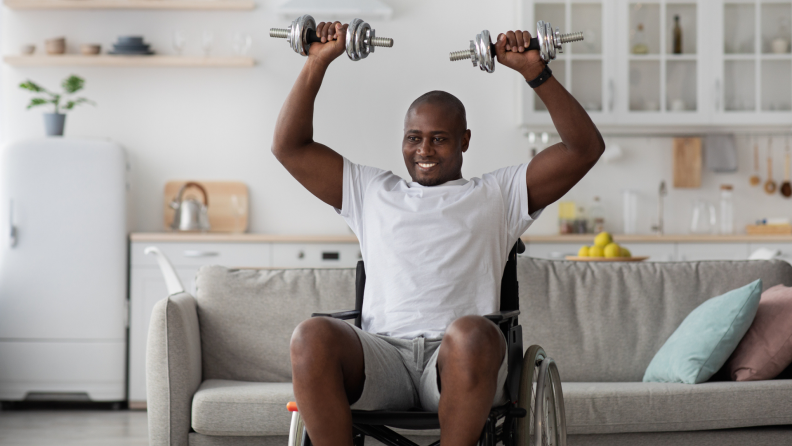 A person lifts weights at home.