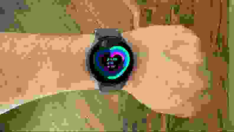 Close-up of a wrist wearing the smartwatch displaying a heart monitor.