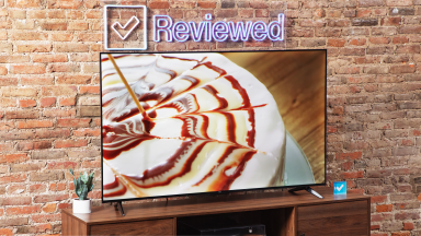 The TCL S4 LED TV on an entertainment center with a brick background.