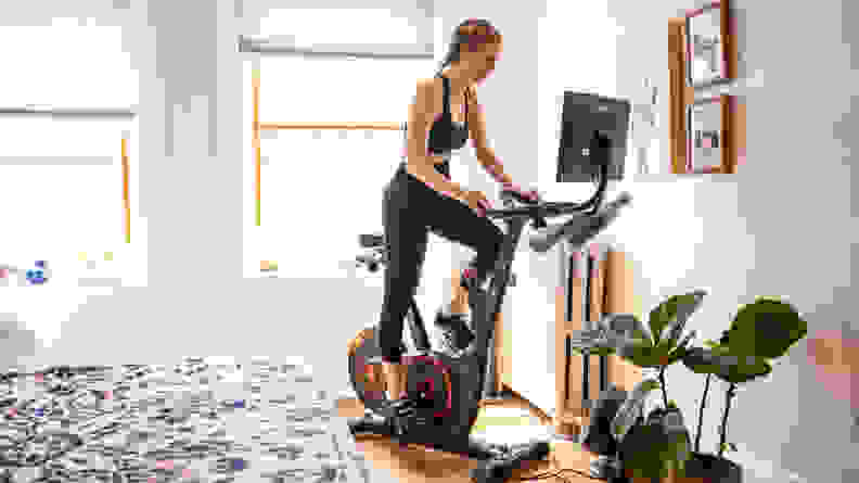 A person works out on the Echelon stationary bike in their bedroom.