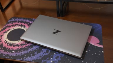 The HP ZBook sits on a desk mat.