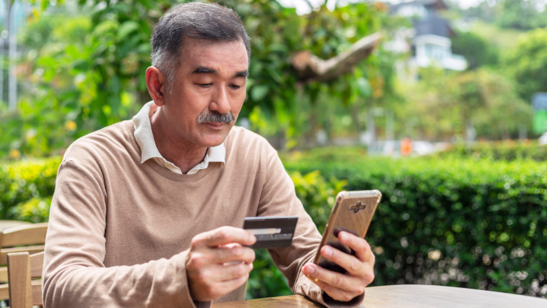 A person buys something on their phone.