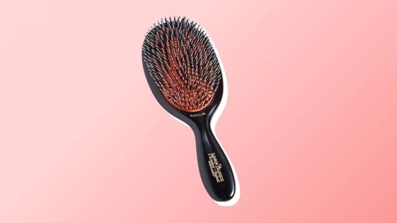 One of the best hair brushes from Mason Pearson against a red gradient background.