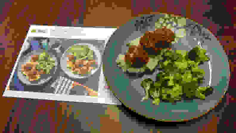 A plate BBQ Beef Meatballs with Smashed Potatoes beside a recipe card.