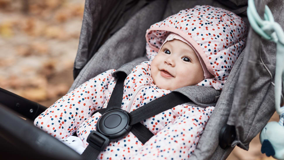 A baby in buckled into a stroller