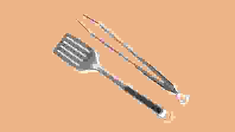OXO grill spatula and tongs on peach background
