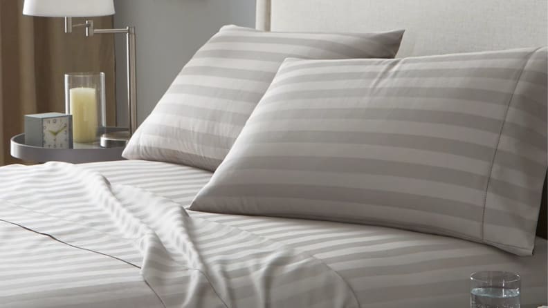 Sand colored Charter Club Damask stripe 100% Supima cotton 550-thread count sheets on bed.