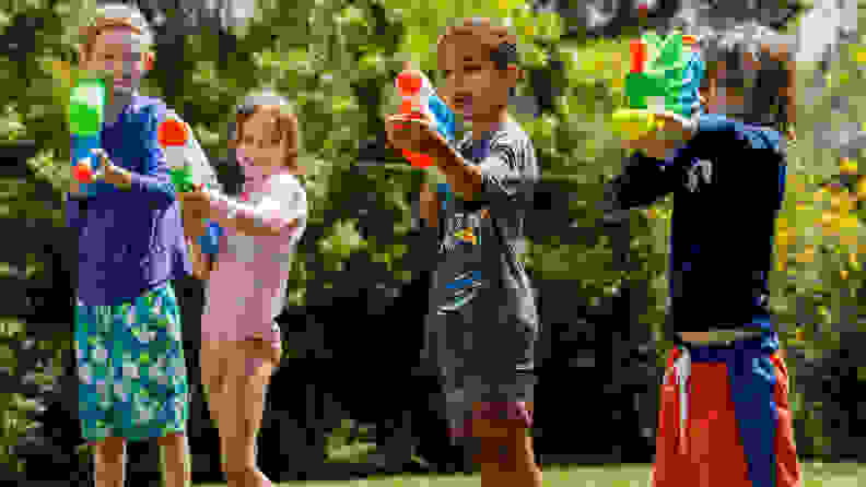 Four kids with all kids of super soakers