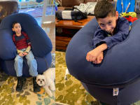 Boy lounges on a Yogibo bean bag.