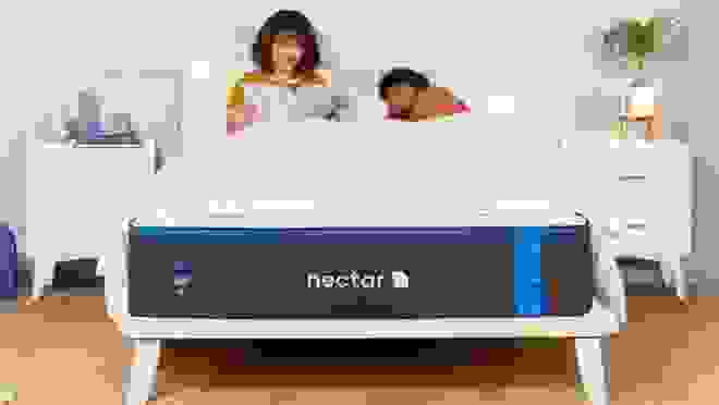 Nectar mattress with woman reading and her partner sleeping in it
