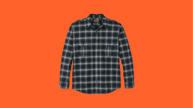 Navy plaid flannel shirt against orange background