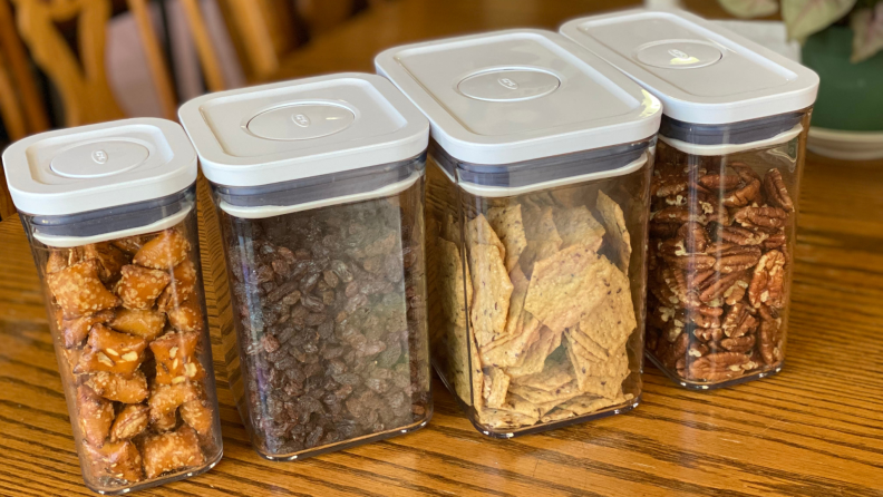 Clear food storage containers with food inside on top of table top.