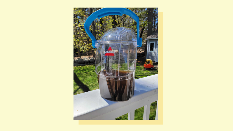 A container of dirty water sits on a ledge.