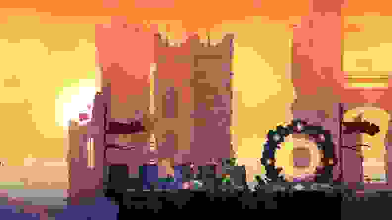 A screenshot of the Dead Cells iOS game, showing the main character near a portal as the sun sets.