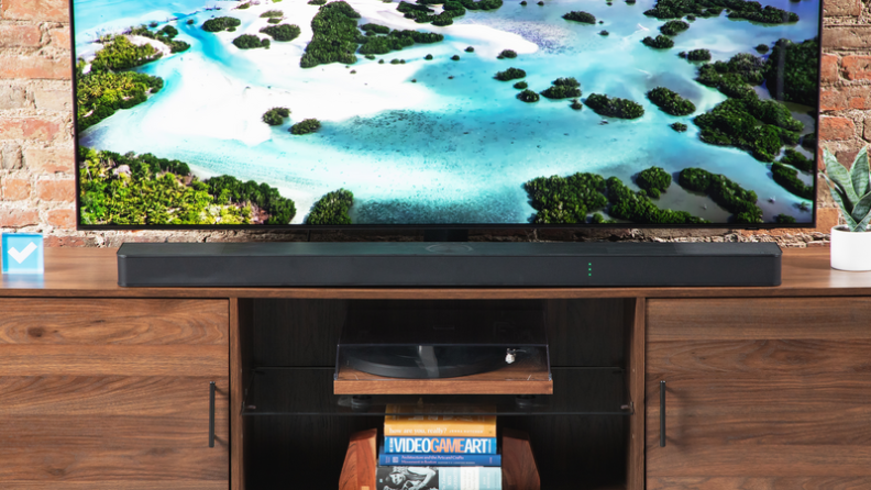 The LG S95TR soundbar below a flatscreen.
