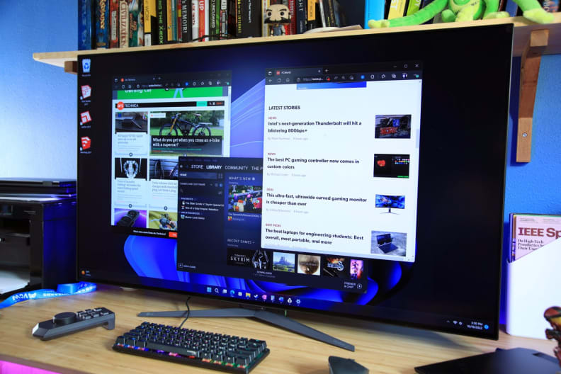 Wide screen LG computer monitor on desk.