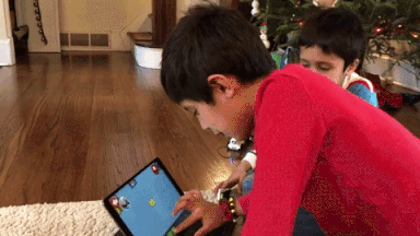Two boys watch the coding in the LEGO BOOST app come to life
