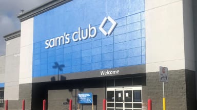 A Sam's Club storefront with a blue and white exterior, featuring the store's logo and entrance.
