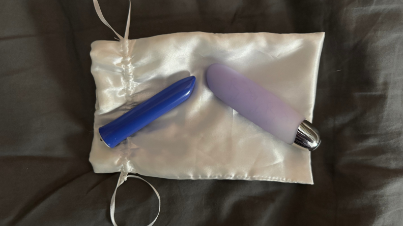 Two bullet vibrators on a silk bag.