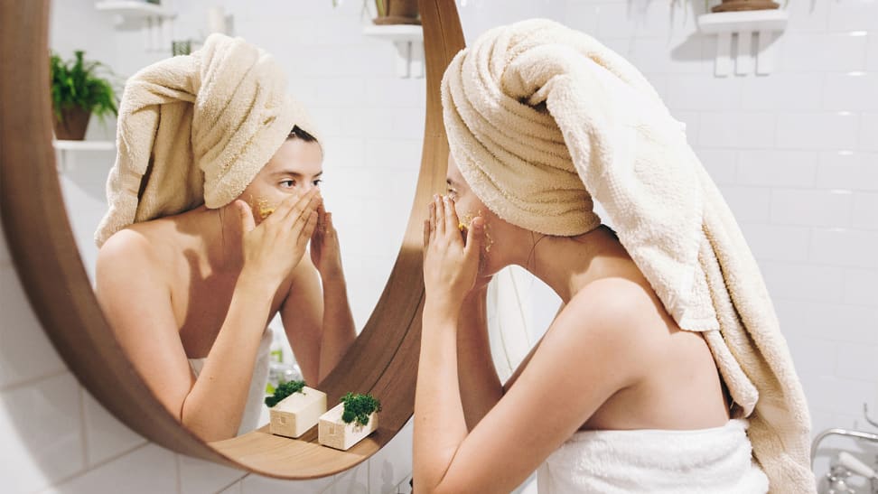 A photo of a woman applying moisturizer.