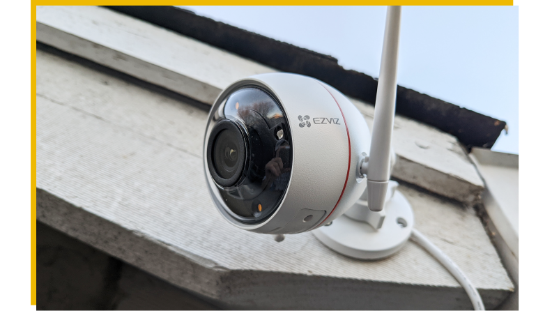 The Ezviz C3W Pro hangs on the side of a house