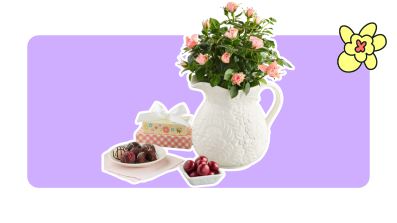 A white pitcher of flowers, and plates of sweet snacks.