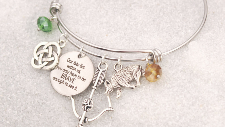 A silver bracelet featuring charms from the movie Brave