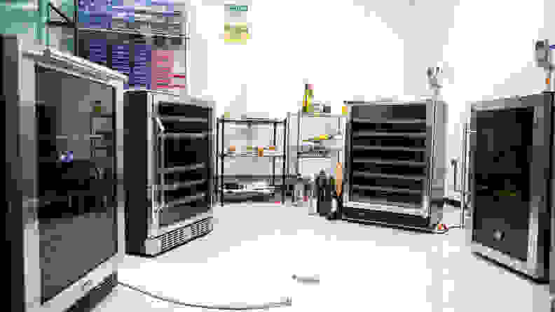 Four different wine fridges are set up in a semi-circle in Reviewed's refrigerator laboratory.