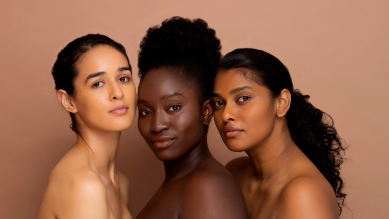 Three women on a brown background