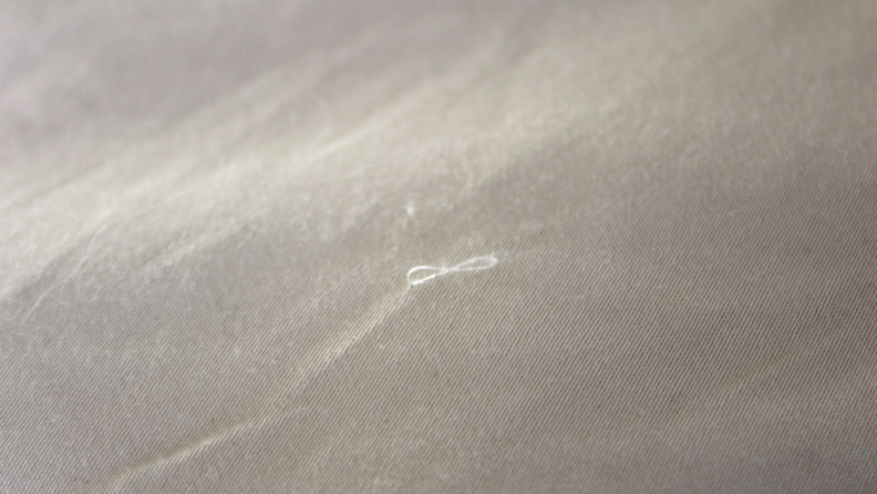 Close up of the duvet showing a thread coming out.