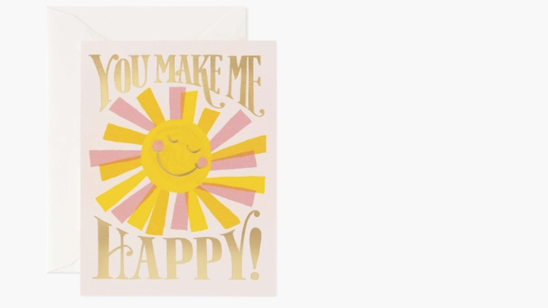 A cartoon sun with a smiley face is centered on a greeting card, which reads: "You make me happy!"