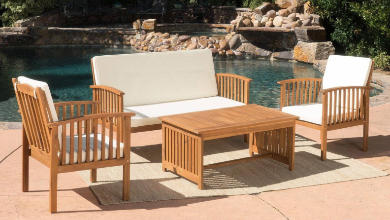 beige patio furniture set next to a pool