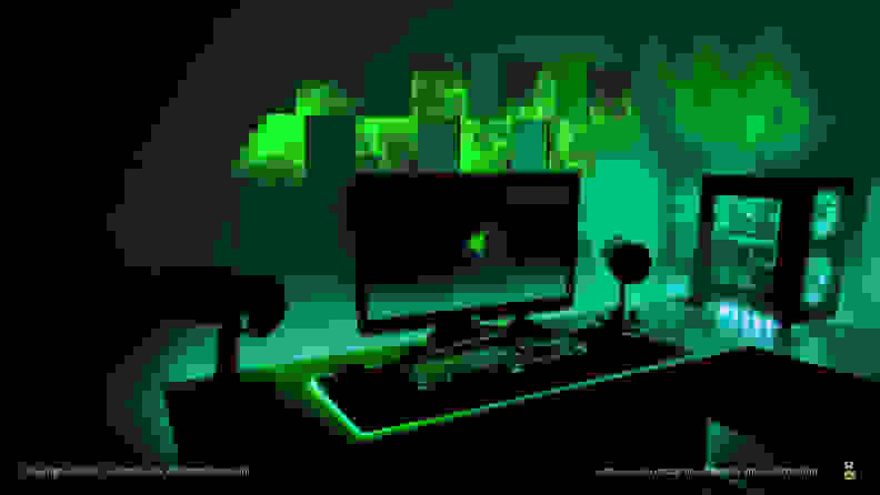 A picture of a gaming setup with several light panels on the wall, displaying low-res, glitchy-looking art.
