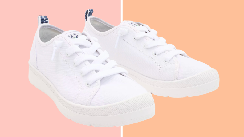 Pair of white Sketchers sneakers on a pink and orange background