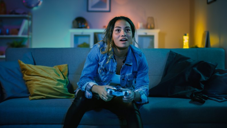 Teen girl playing video games in the dark