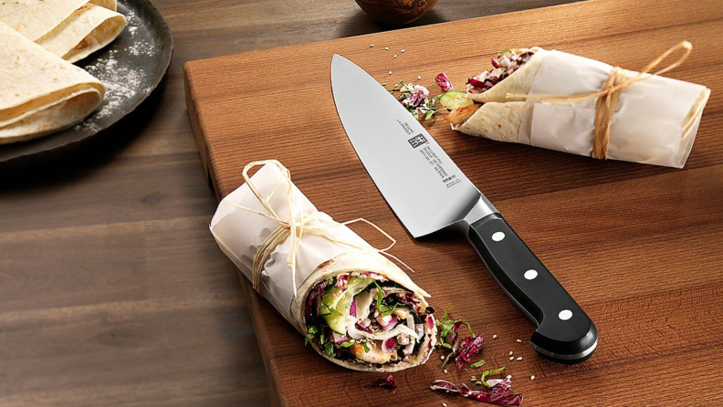 A Zwilling knife on a cutting board.